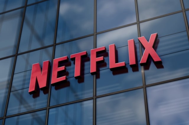 The Netflix logo mounted on the glass facade of an office building